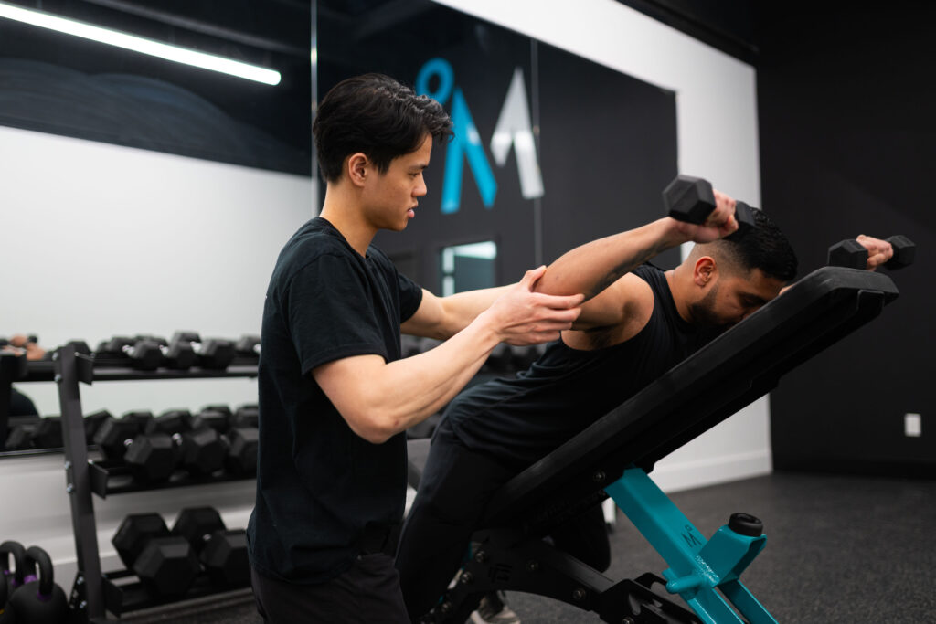 Andrew treating client in gym